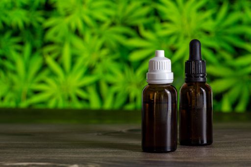 A closeup of CBD oils in brown glass bottles