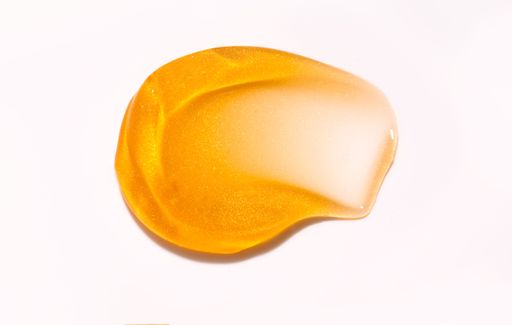 The gold skincare texture on a white background