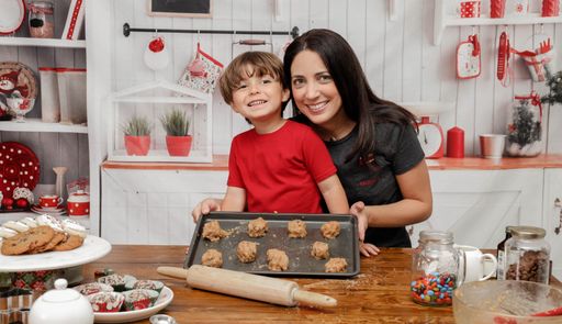 A mother baking Christmas cookies with her son
