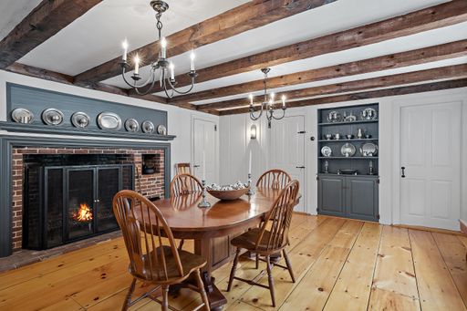 A vintage dining room interior design with wooden furniture and flooring and old style chandeliers