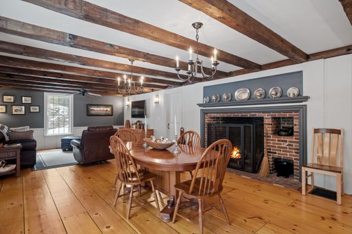 A vintage dining room interior design with wooden furniture and flooring and old style chandeliers