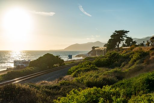 A sunset view of the Pacific Ocean and railroad tracks at a Ventura County beach, California, USA