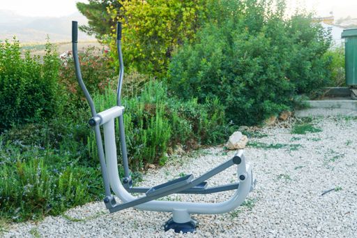 exercise equipment in the park with gardens in the background