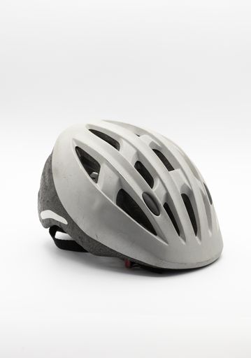 A vertical closeup shot of a bicycle helmet isolated on a white background