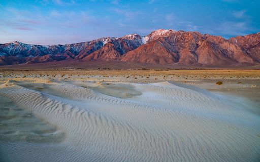 A dramatic desert sunrise at the natural sand dunes in California's Eastern Sierra region.