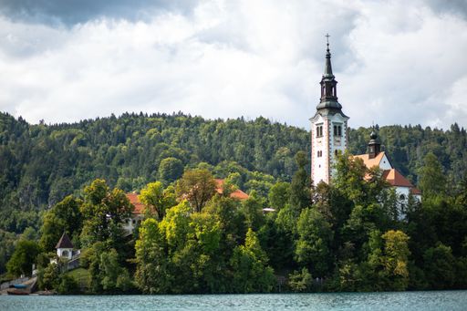 A beautiful shot of a historic church tower surrounded by trees near Lake Bled in Slovenia