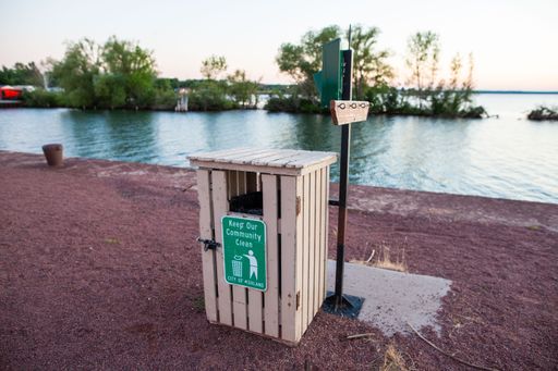 A city of Ashland wooden trash bin near water in Wisconsin