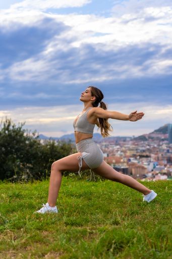 A young Caucasian female doing workout outdoors - healthy lifestyle concept