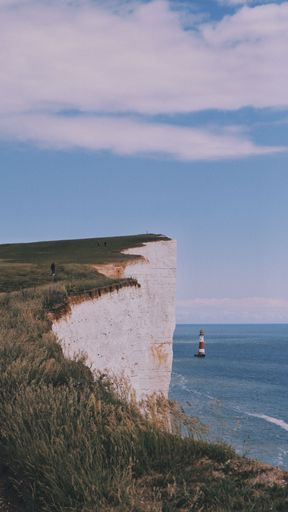 A vertical shot of the Beachy Head, the highest chalk sea cliff and the lighthouse in East Sussex, England