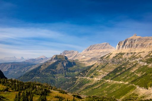 A scenic landscape of mountain forests during daytime in Glacier National Park, Montana