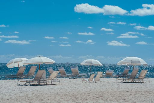 A natural view of beach lounges and umbrellas on the seaside during summer