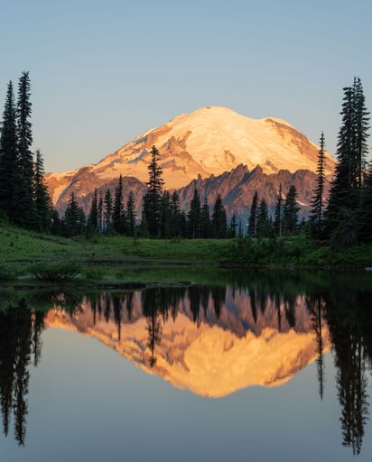 A vertical shot of Sunrise on Mt Rainier mountain reflecting in Tipsoo lake