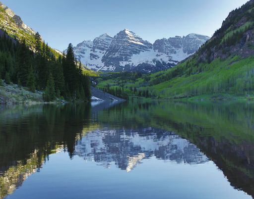 The scenic maroon bells mountains peaks reflected in the water