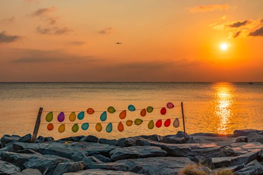 A golden sunset and colorful balloons over the cliffs