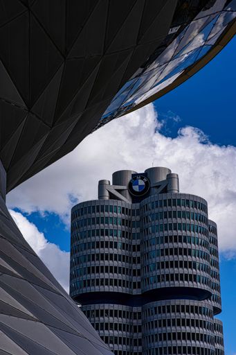 a vertical shot of BMW headquarters building in Munich, Germany with blue sky