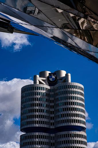 a vertical shot of BMW headquarters building in Munich, Germany with blue sky