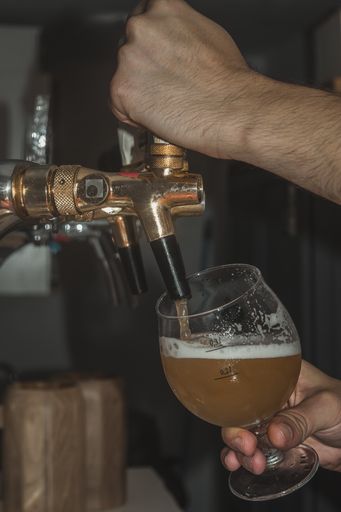 A vertical shot of barmen pouring craft beer