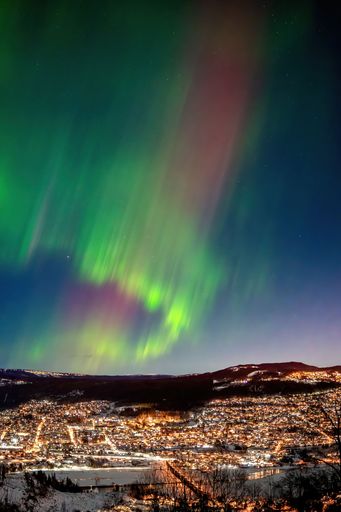 A vertical shot of beautiful polar lights above Lillehammer, Norway.