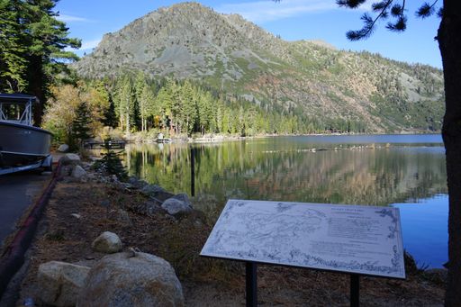 A scenic view of Lake Tahoe in California, USA with info plaque on the shore