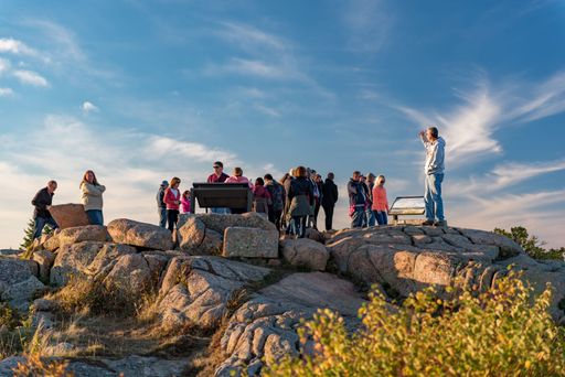 A group of tourists enjoying the fall day in in Acadia National Park, ME, USA