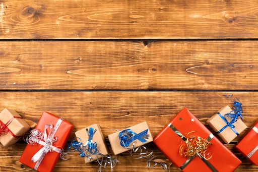 A Christmas background with gift boxes on wooden board
