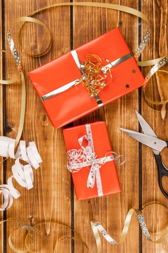 A Christmas background with decorations and gift boxes on wooden board