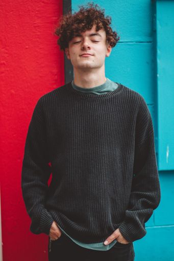 A vertical shot of an attractive South African man with closed eyes