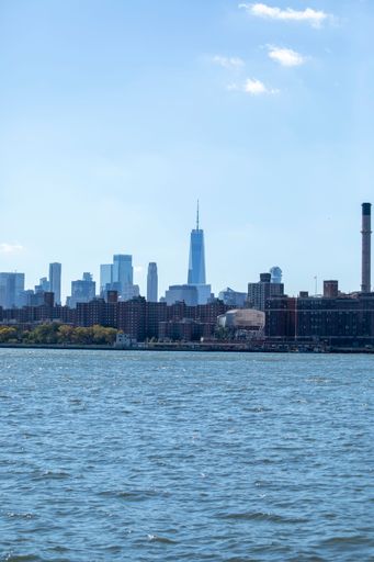 A vertical shot of a view of Manhattan from the water in New York City, United States.