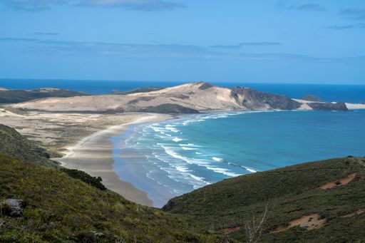 The Ninety Mile Beach on the Pacific Ocean shore with a blue sky in the background, New Zealand