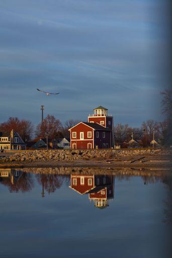 A vertical shot of a lighthouse during sunset at Luna Pier, Michigan