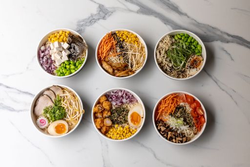 A top view of delicious poke bowls on the marble table