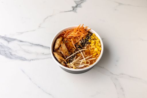A top view of a tasty poke bowl with corn on the marble table