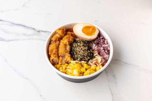 A tasty poke bowl with chicken and egg on the marble table