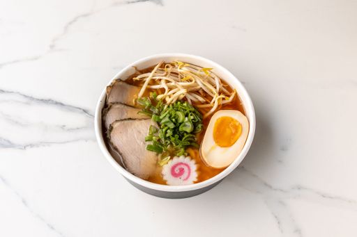 A top view of a tasty beef noodle soup on the marble table
