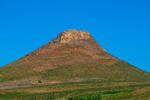 The Prison of Solomon hollow cone-shaped hill under a clear blue sky in West Azerbaijan Province, Iran.