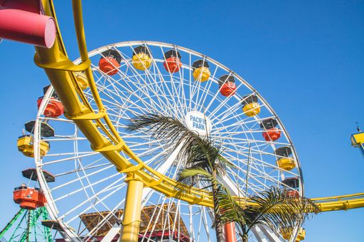 A low angle shot of the Ferris wheel of the Pacific Park in Santa Monica, United States