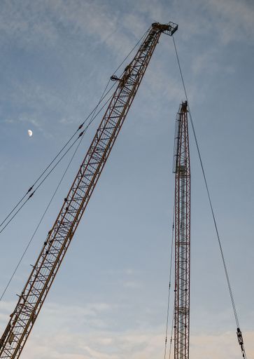 construction site with cranes and sky and moon
