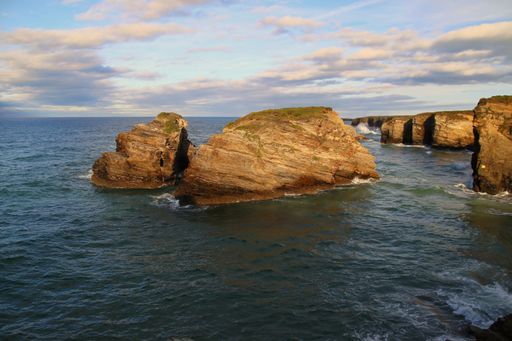 A beautiful shot of huge cliffs during the high tide, the beach of the Cathedrals in Ribadeo Lugo, Galicia