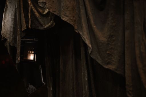 A closeup shot of an old hanging lantern covered with a curtain in an abandoned place