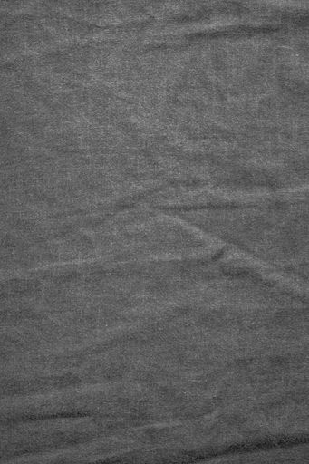 A vertical overhead shot of black denim - great for background