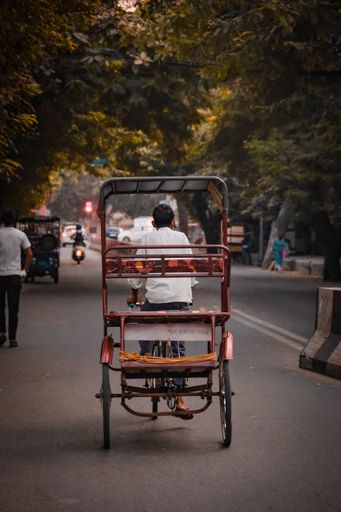 A boy on a rickshaw in the streets of Dehli, India
