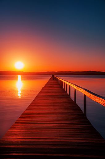 A vertical shot of a breathtaking sunset with extraordinary colors reflecting in the sea