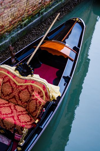 A vertical high angle closeup shot of a boat in the beautiful city of Venice