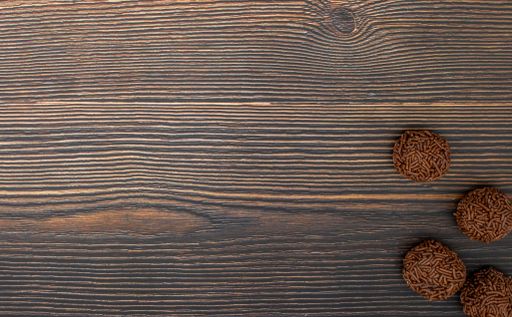 A top view of chocolate Brazilian Brigadeiro on a wooden table with copy space