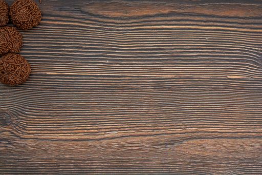 A top view of chocolate Brazilian Brigadeiro on a wooden table with copy space