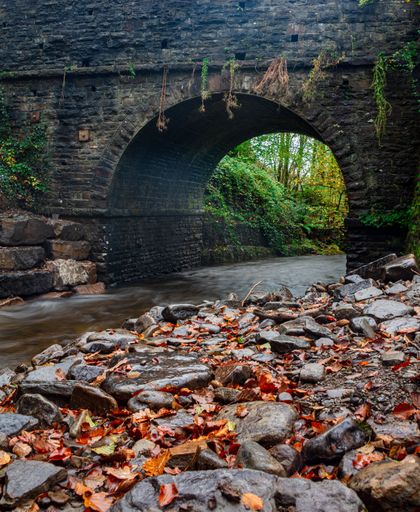 An old stone bridge over a calm river