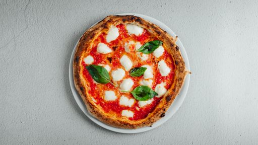 A top view of a pizza Margherita on a table