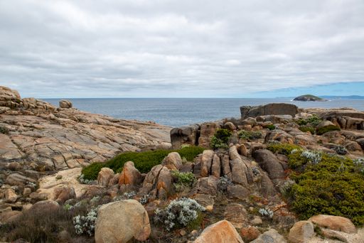 A beautiful shot of a lot of rock formations near the sea under the cloudy sky