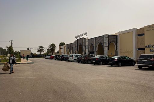 Cars parked in front of the natural bath of Ain Allah i