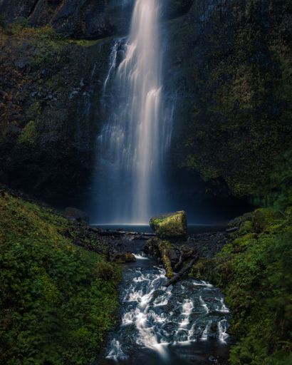 The water cascades from the top of Multnomah Falls into a small basin